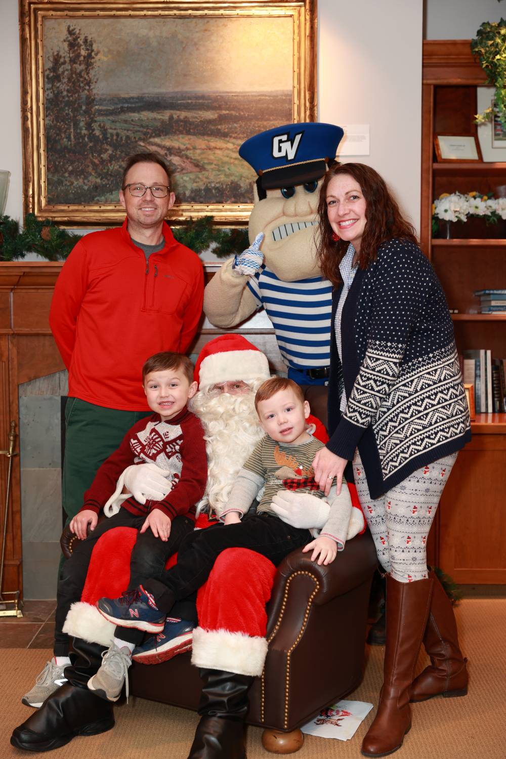 Parents and their two sons with Santa & Louie.